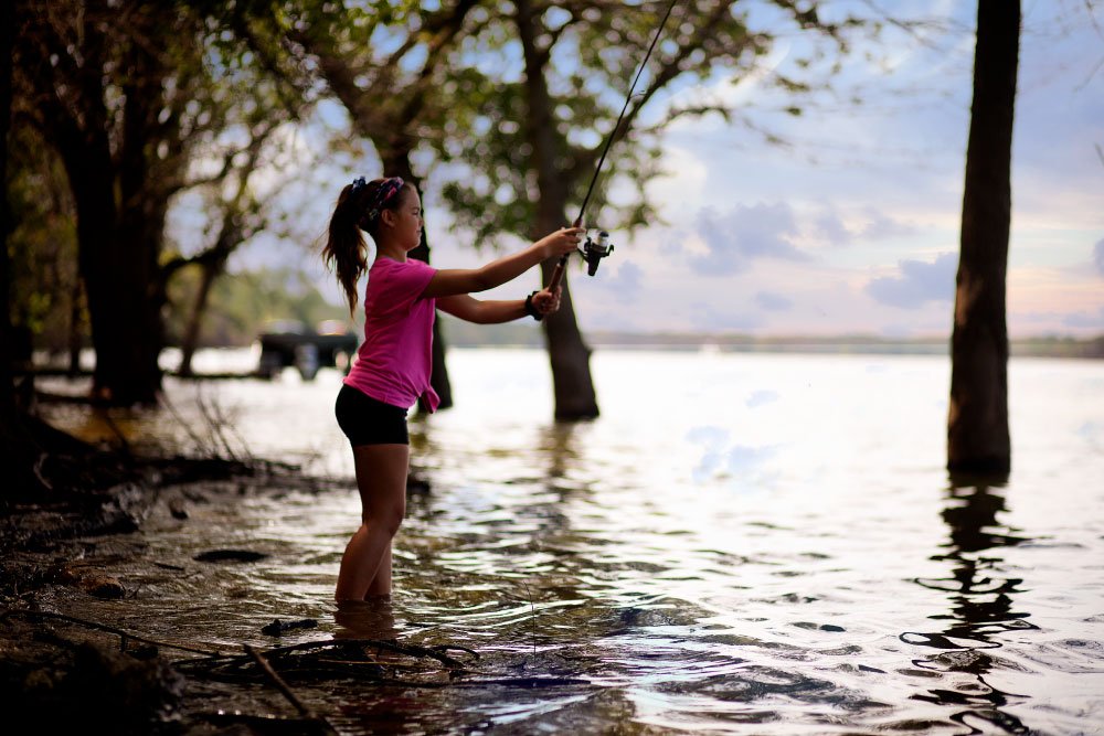 Young Girl Fishing on the Mississippi Universal Apex Construction and Roofing